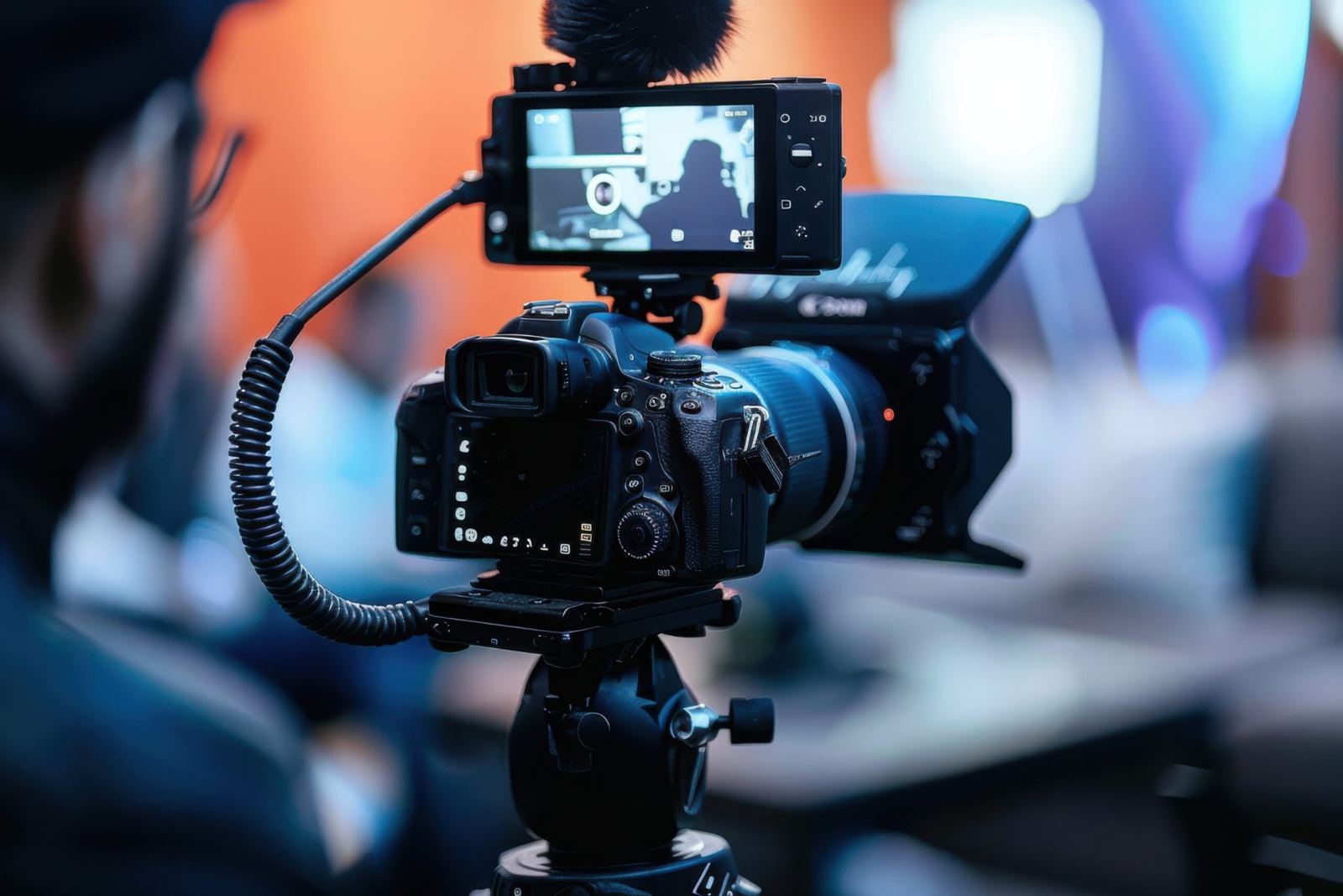 Professional video camera filming a fintech conference keynote stage