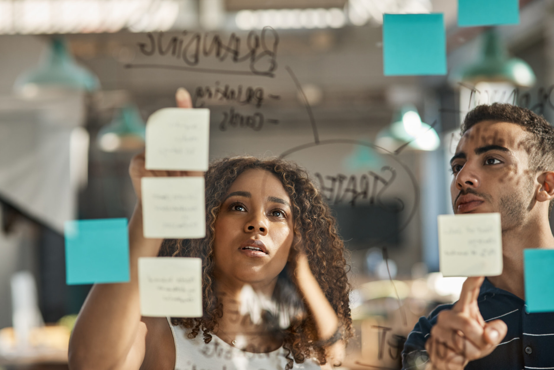 Executive team mapping strategy on sticky notes in a modern workspace